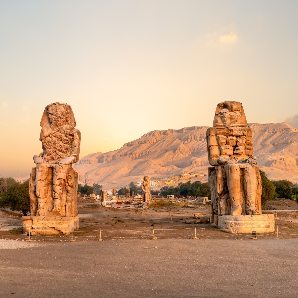 Colossi of Memnon Guarded The Mortuary Temple Of King Amenhotep III. Visit The Colossi of Memnon On A Day Trip To Luxor With 123 Taxi & Tours Hurghada